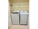 Laundry room featuring a new Samsung washer and dryer and shelf at 15851 Woodland Spring Ct, Orlando, FL 32828