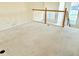Spacious loft area features neutral carpet and a decorative railing at 15851 Woodland Spring Ct, Orlando, FL 32828
