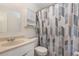 Cozy bathroom featuring a vanity with storage and a shower with stylish curtain at 1622 Crystalview Trl, Lakeland, FL 33801