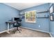 Bright bedroom with a desk, shelves, and a window overlooking the outdoors creating a welcoming workspace at 1622 Crystalview Trl, Lakeland, FL 33801