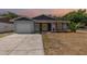 Charming single-story home featuring a well-maintained lawn and a one-car garage at 1622 Crystalview Trl, Lakeland, FL 33801