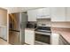Modern kitchen featuring stainless steel appliances and ample counter space at 1622 Crystalview Trl, Lakeland, FL 33801