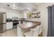 Well-lit kitchen featuring modern stainless steel appliances and countertop seating at 1622 Crystalview Trl, Lakeland, FL 33801