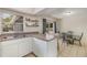Eat-in kitchen area with barstool seating and a dining table near sliding glass doors at 1622 Crystalview Trl, Lakeland, FL 33801