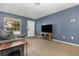 Bright living room with a large window, plush carpet, and comfortable seating area at 1622 Crystalview Trl, Lakeland, FL 33801