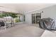 Spacious covered patio area with a table, chairs, and a grill, perfect for outdoor entertaining at 1622 Crystalview Trl, Lakeland, FL 33801