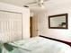 Bright bedroom features closet, ceiling fan, and large mirror at 1820 Hallcrest Dr, Deltona, FL 32725