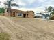 Single-story home with stucco exterior, brown roof, landscaped yard and a two car garage at 1820 Hallcrest Dr, Deltona, FL 32725