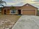 Charming single-story home features a two-car garage and long driveway at 1820 Hallcrest Dr, Deltona, FL 32725