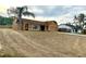 Front exterior with a large lawn, driveway, and mature palm trees at 1820 Hallcrest Dr, Deltona, FL 32725