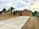 Home features a long driveway, palm trees, and a 2-car garage at 1820 Hallcrest Dr, Deltona, FL 32725