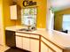Kitchen area featuring white cabinets, stainless appliances and view into the living area at 1820 Hallcrest Dr, Deltona, FL 32725