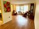 Bright living room featuring hardwood floors, large windows, and comfortable seating at 1820 Hallcrest Dr, Deltona, FL 32725