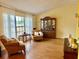 Living room with ample light featuring hardwood floors and a view into the dining room at 1820 Hallcrest Dr, Deltona, FL 32725