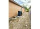 Side yard shows the AC unit and wood fence on a home's exterior at 1820 Hallcrest Dr, Deltona, FL 32725