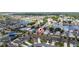 Aerial view of a suburban neighborhood with a lake, showcasing a community of single-Gathering homes at 1821 Cayman Cove St., St Cloud, FL 34772