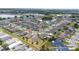 Aerial view of a well-planned community featuring single-Gathering homes with manicured lawns and a scenic pond at 1821 Cayman Cove St., St Cloud, FL 34772
