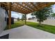 Relaxing backyard patio with a covered pergola overlooking the expansive green space and fenced yard at 1821 Cayman Cove St., St Cloud, FL 34772