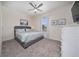 Cozy bedroom with a queen-sized bed, carpet flooring, and natural light from the window at 1821 Cayman Cove St., St Cloud, FL 34772