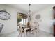 Elegant dining area featuring a wooden table, chandelier lighting, and sliding glass doors to the backyard, perfect for meals at 1821 Cayman Cove St., St Cloud, FL 34772