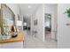 Bright entryway showcasing tile floors, an ornate mirror, and an open view into the living spaces, exuding a welcoming ambiance at 1821 Cayman Cove St., St Cloud, FL 34772