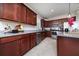 Modern kitchen featuring dark wood cabinets, granite countertops, and stainless steel appliances, blending style and functionality at 1821 Cayman Cove St., St Cloud, FL 34772