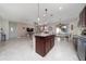 Modern kitchen featuring granite countertops, stainless steel appliances, and an adjacent dining area at 1821 Cayman Cove St., St Cloud, FL 34772