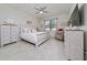 Bright main bedroom featuring tile floors, a dresser and a ceiling fan at 1821 Cayman Cove St., St Cloud, FL 34772
