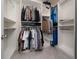 Organized walk-in closet featuring custom shelves, ample hanging space, and a neutral color palette at 1821 Cayman Cove St., St Cloud, FL 34772
