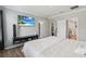 Bedroom with neutral walls featuring a wall-mounted TV and multiple doorways creating an open feel at 2281 Canyon Breeze Ave, Kissimmee, FL 34746
