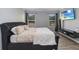 Comfortable bedroom featuring a tufted headboard and a wall-mounted TV for relaxed viewing at 2281 Canyon Breeze Ave, Kissimmee, FL 34746