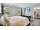 Cozy bedroom with natural light, wall-mounted TV, and sleek floating shelf under the television at 2281 Canyon Breeze Ave, Kissimmee, FL 34746