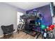 Bedroom with a lofted bed, desk, gaming chair and a wall mural creating a fun space at 2281 Canyon Breeze Ave, Kissimmee, FL 34746