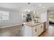 Kitchen with modern island, stainless steel appliances, and natural light at 2281 Canyon Breeze Ave, Kissimmee, FL 34746