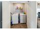A laundry room featuring a washer, dryer, and shelving for storage, perfect for efficient home management at 2281 Canyon Breeze Ave, Kissimmee, FL 34746