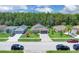 Aerial view of the home showcasing the neighborhood and surrounding landscaping and well manicured lawns at 2398 Queenswood Cir, Kissimmee, FL 34743