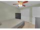Bedroom features a ceiling fan, tile floor, and dark-colored furniture set at 2398 Queenswood Cir, Kissimmee, FL 34743