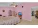 Bright and inviting bedroom with comfortable bed, ceiling fan, and seamless access to the en-suite bathroom at 2398 Queenswood Cir, Kissimmee, FL 34743