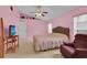 Cozy bedroom featuring a comfortable bed, ceiling fan, and a bright window, ideal for rest and relaxation at 2398 Queenswood Cir, Kissimmee, FL 34743