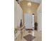 Inviting foyer with decorative tile accents, complemented by a stylish console table and elegant lighting fixture at 2398 Queenswood Cir, Kissimmee, FL 34743