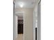 Hallway leads to bathroom with tiled shower and bedroom with neutral paint at 2398 Queenswood Cir, Kissimmee, FL 34743