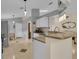 Open kitchen featuring granite counters, white cabinets, and stainless steel appliances at 2398 Queenswood Cir, Kissimmee, FL 34743