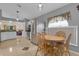 Open kitchen featuring tile floors, stainless appliances, and a wooden breakfast table at 2398 Queenswood Cir, Kissimmee, FL 34743
