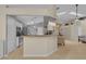 Open-concept kitchen and living area with bar seating and modern appliances at 2398 Queenswood Cir, Kissimmee, FL 34743