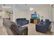 Bright living room with tile flooring, comfortable seating, and entertainment center, offering a relaxing atmosphere at 2398 Queenswood Cir, Kissimmee, FL 34743