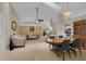 Open-concept living and dining area with vaulted ceilings and neutral tile flooring at 2398 Queenswood Cir, Kissimmee, FL 34743