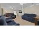 Spacious living area featuring plush seating, tile flooring, and a seamless transition to the modern kitchen at 2398 Queenswood Cir, Kissimmee, FL 34743