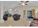 Relaxing living room with tile flooring, plush sofas, and access to the outdoor screened patio at 2398 Queenswood Cir, Kissimmee, FL 34743
