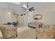 Open concept living room features tile flooring, vaulted ceilings, and natural light from skylight, seamlessly connected to dining area at 2398 Queenswood Cir, Kissimmee, FL 34743