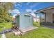 Backyard shed with concrete foundation and grill, provides extra storage space for lawn equipment at 2398 Queenswood Cir, Kissimmee, FL 34743